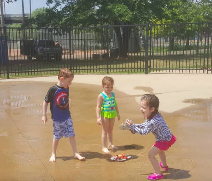 Kids have fun playing in the water at the Rogers Park sprayscape in Danbury. From left, Cameron DeMato, Jemma DeMato and Emily Frascione.