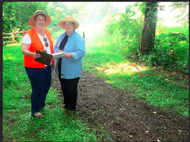 Midge Kennedy and Sarah Graver, vice-presidents of the Norwalk Land Trust, on the Wood Acre Road site.