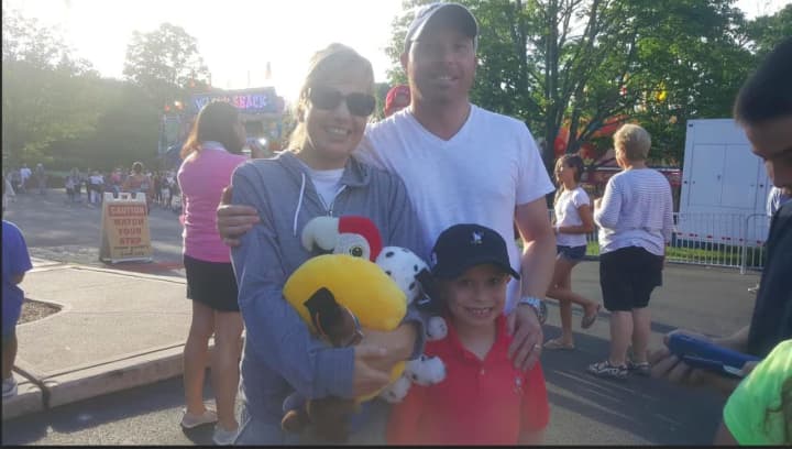 Shannon and Jim Lombardo of Easton with their 7-year-old son Evan. They also have a 6-year-old son Nico. The kids are having fun at the 75th annual Easton Fireman&#x27;s Carnival.