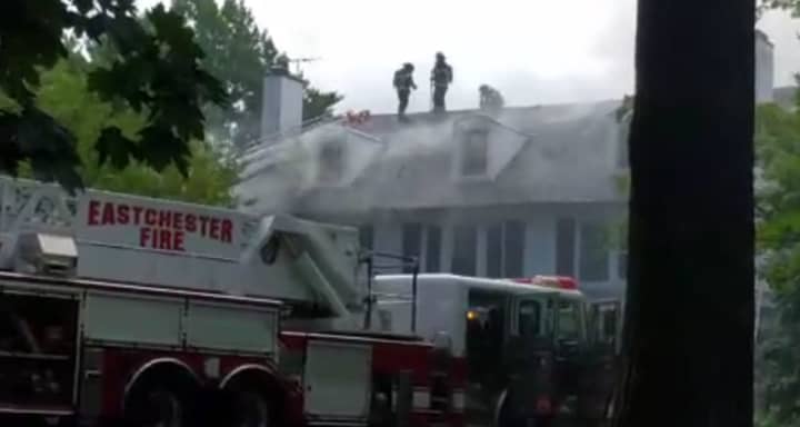 Firefighters continue to battle the two-alarm fire at an Elm Street home in Bronxville.