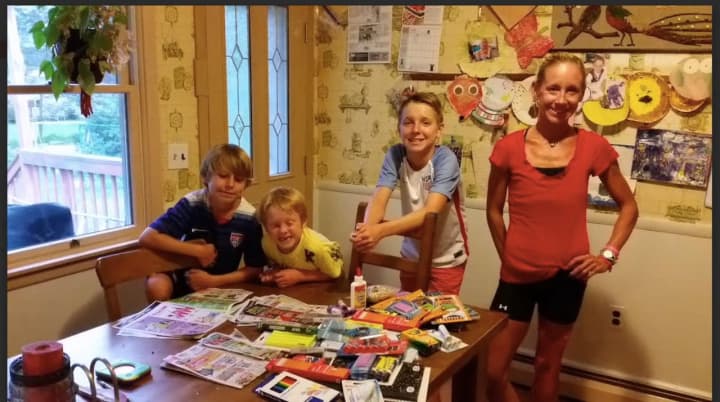 From left, Evan, 9; Aaron, 6; Ian 13; and mom, Sara Belles, with some of the back to school items they purchased
