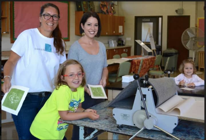 DAC’s Visual Arts Director Beth Cherico and Visual Arts Instructor Jill Sarver help young guests with a printmaking project in the DAC Visual Arts Studio.