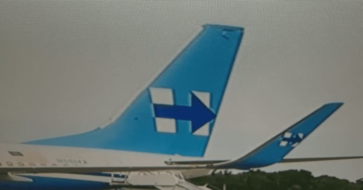 The campaign logo “H” appears on the tail of the 737.