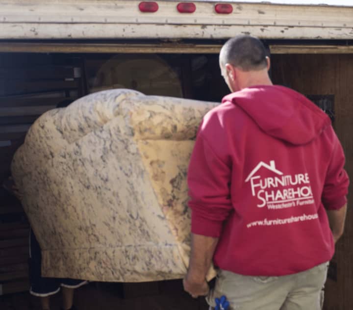 Furniture Sharehouse driver Dave Vitullo loads a sofa into a truck for one of the charity&#x27;s many deliveries across Westchester.
