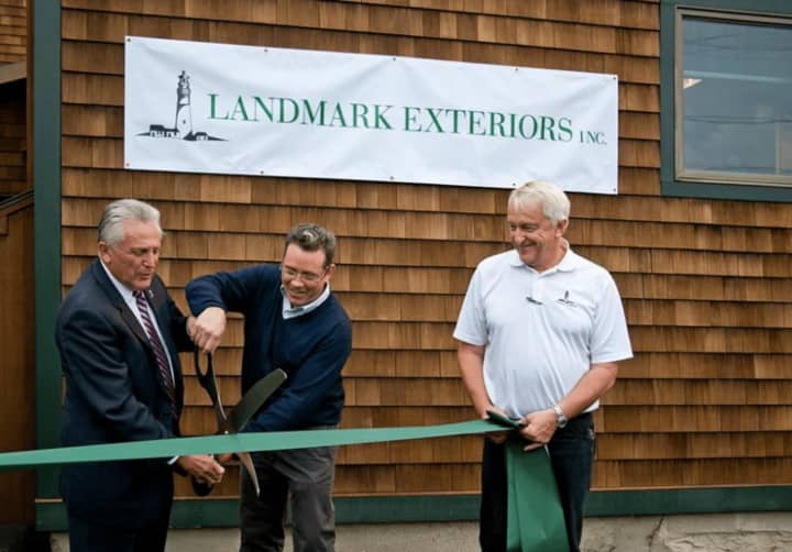 Scott Teed of Landmark Exteriors joins Norwalk Mayor Harry Rilling in a ribbon cutting at the company&#x27;s expanded location in Norwalk.