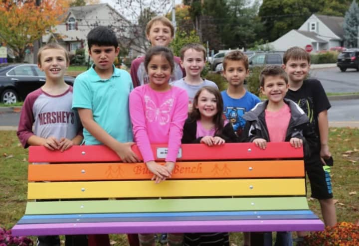 H.B. Milnes students with one of their new buddy benches.