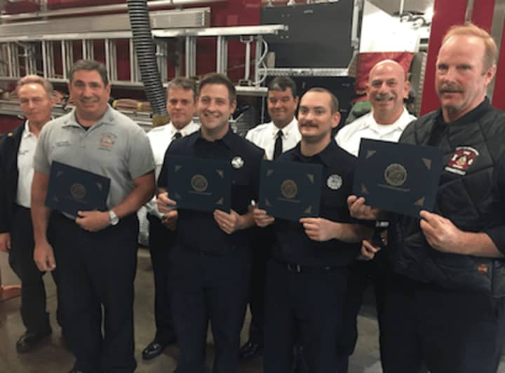 Front, L-R, Capt. Shaun Tripodi, firefighters Keven O&#x27;Brien, Kevin Campbell and Richard Walsh with their award in aiding a man. Back, L-R, Assistant Chief Robert Morris, Asst. Chief Mike Robles, Chief Trevor Roach and Deputy Chief Patrick Tripodi.