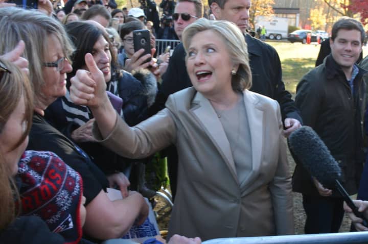 Hillary Clinton gives a thumbs up while meeting with supporters and reporters after casting her presidential vote in Chappaqua.
