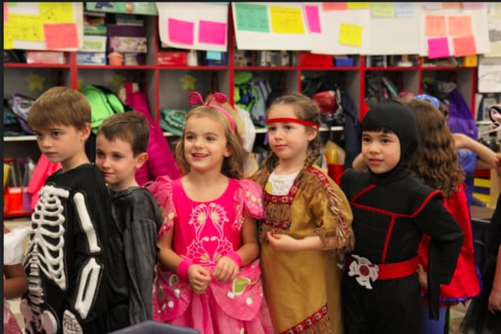 Kindergartners, from left, Connor Gonnella, John Hall, Ellery Kraus, Lily Ryan and Jace Tamaye get ready to head outside for the Holmes School annual Halloween parade.