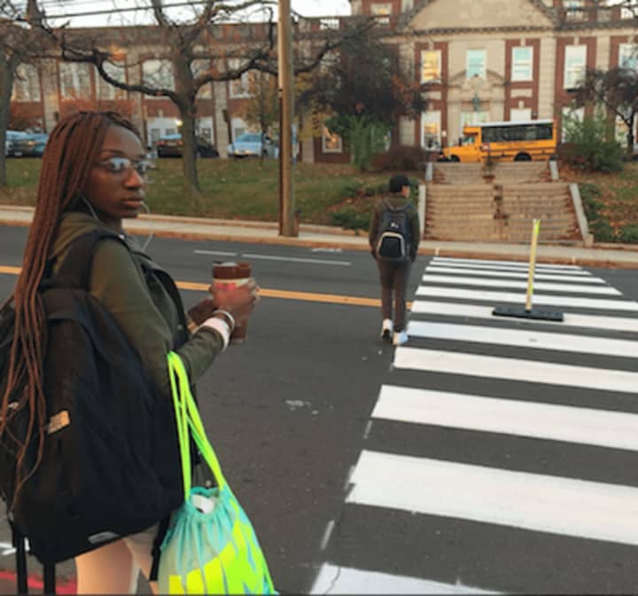 Earthaiza Watkins, at left, a junior at Stamford High School, says the new crosswalk in front of the school makes crossing the street much safer.