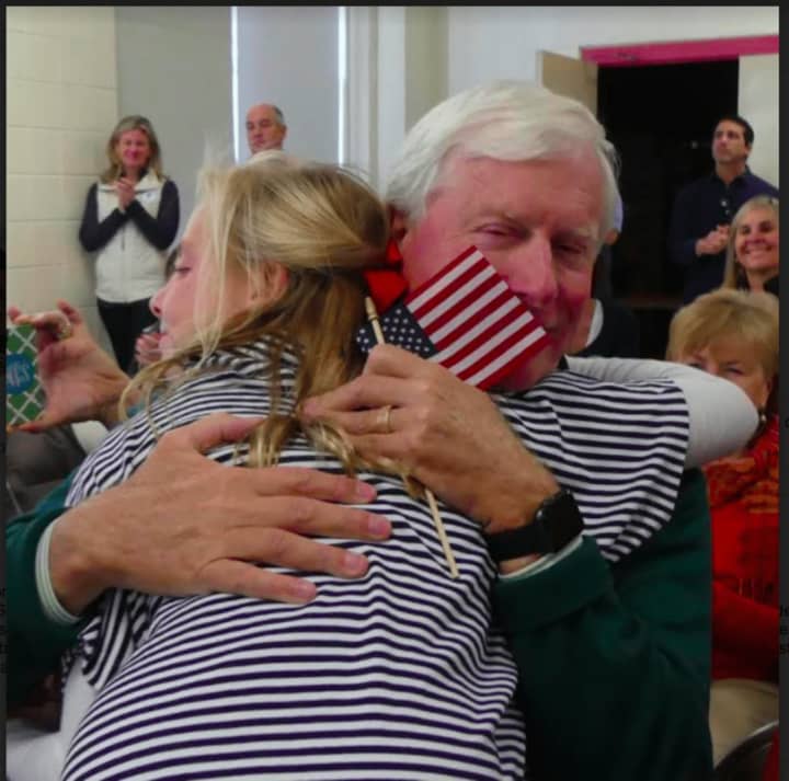Fourth-grader Whitney Grunow hugs her grandfather John O. Wolcott, who served in the Army for three years in Vietnam and in the Army Reserves for three years.