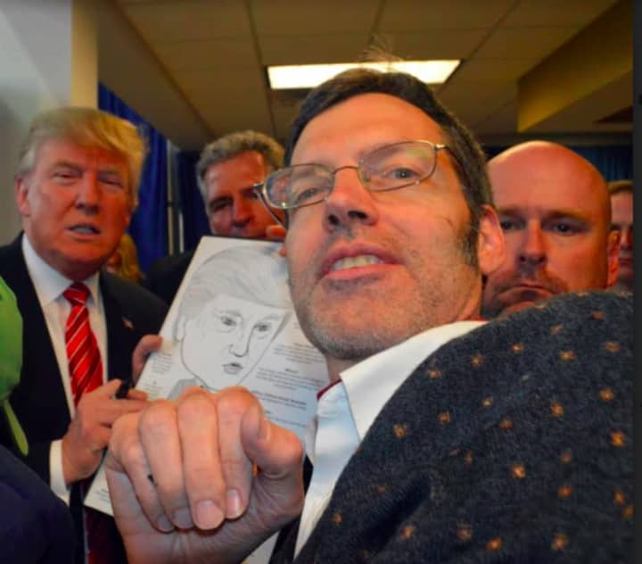 Political cartoonist and caricature artist and Darien resident Bob Carley presenting his caricature to president-elect Donald Trump