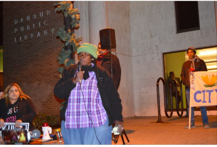 Glenda Armstrong, president of the local NAACP chapter, speaks in front of the Danbury Library Thursday evening at the Danbury Vigil for Unity and Justice.