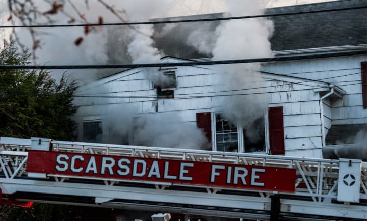 Firefighters with the Scarsdale Fire Department battling the blaze on Sunday at the home of Dr. John and Marie Salimbene.