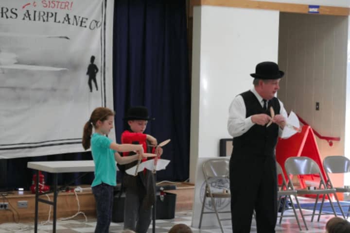Second-graders Sarah Ryan and Tommy Walsh participate in Patrick Garner&#x27;s presentation of The Wright Brothers and Sister.