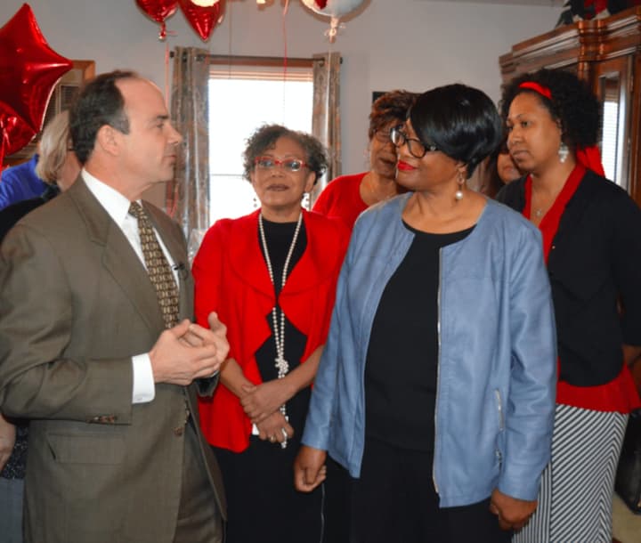 Bridgeport Mayor Joe Ganim chats with Joann Smith in her new home on Oakwood Street.