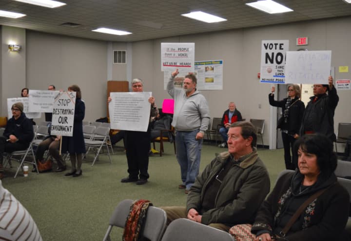 Members of Save Our Shelton held up signs and advanced on the Planning &amp; Zoning Commission during a Thursday meeting.