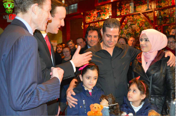 Sen. Richard Blumenthal (left) welcomes a Syrian family that had been denied entry to the U.S. due to President Donald Trump&#x27;s travel ban. Blumenthal is calling on Trump to abandon any religious tests in his approach to national security.