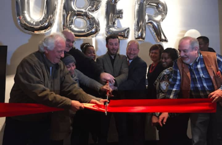 Matt Powers, General Manager for Uber in Connecticut, center left, and Thomas Madden, Director of Economic Development for City of Stamford, center right, cut the ribbon at the new Uber office in Stamford.