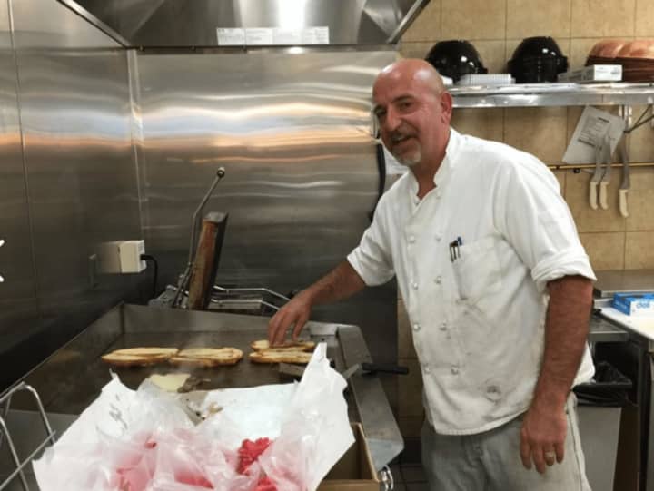 A chef at The Pantry cooks up Philly cheesesteaks.