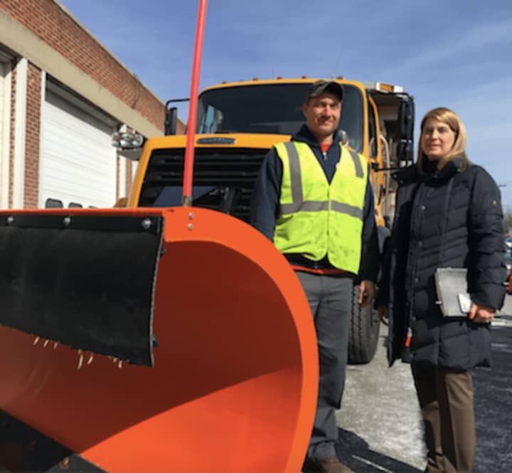 Darien First Selectman Jayme Stevenson, at right, along with David Ward, a labor/driver with the Department of Public Works standing by a snow plow that will be in use during tomorrow&#x27;s anticipated blizzard.