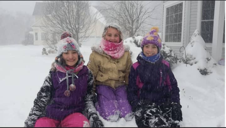 From left, Marianna, Haley and Corinne play in the snow in Danbury. They all had a sleepover last night since school was canceled for the day.