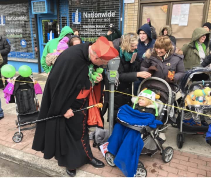 Cardinal Timothy Dolan, grand marshal of the Yonkers St. Patrick&#x27;s Day Parade, greets a youngster on Saturday.