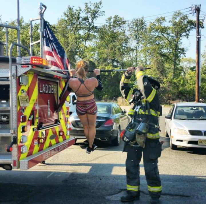 Kirin Hart bangs out some pull ups on a Hackensack fire engine when her gym&#x27;s power went out.