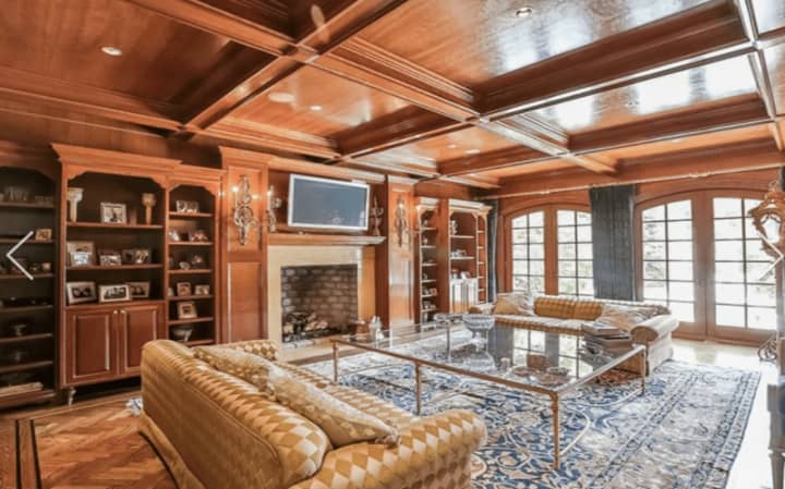 The wood-paneled living room and library at 9 Terrace Circle in Armonk combines elegance and comfort.