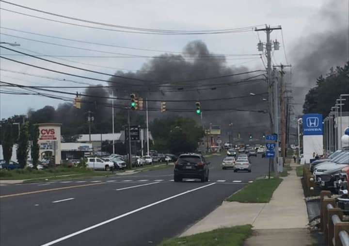 The smoky fire late Tuesday afternoon at a junkyard can be seen for miles in the Milford area.