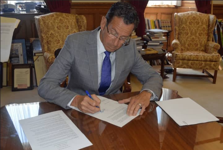 Gov. Dannel Malloy signing Executive Order No. 60 on Wednesday.