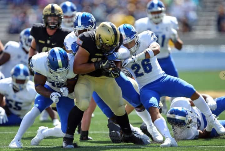 Darnell Woolfolk and Army&#x27;s triple option wore down Buffalo&#x27;s defense in the fourth quarter.