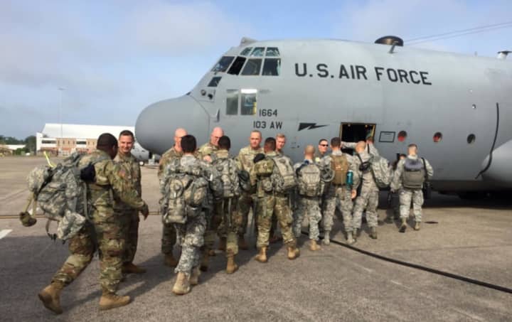 Members of the Connecticut National Guard board a cargo plane Tuesday for Puerto Rico, where they will help establish a communications infrastructure.