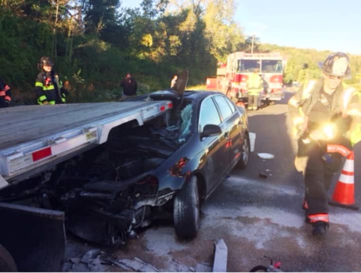 Danbury firefighters respond the scene of a car vs. tractor-trailer near the Exit 2 on ramp of I-84 eastbound during the Friday morning rush hour.