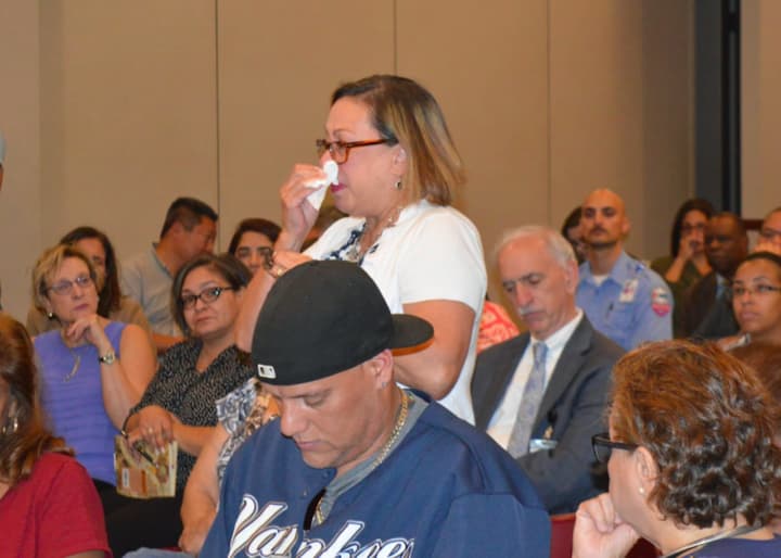 Bridgeport mayoral aide Alma Maya dabs away tears as she speaks of the destruction in Puerto Rico.