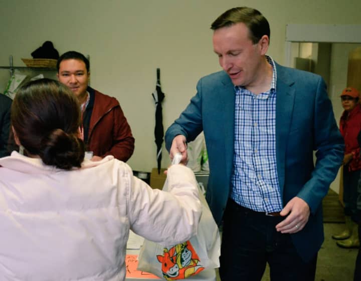 U.S. Sen. Chris Murphy distributes bags of food for Thanksgiving at Person-To-Person in Norwalk on Wednesday.