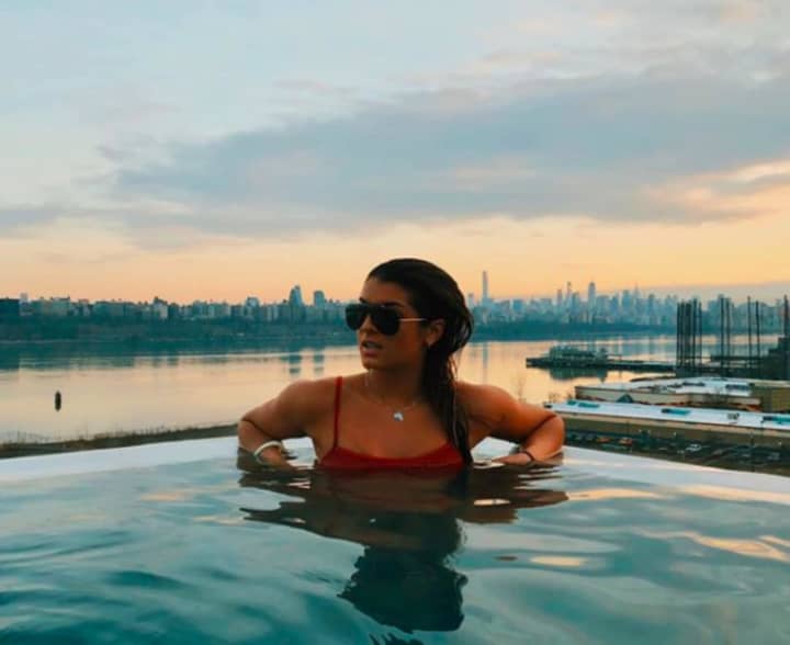The New York City skyline serves as the backdrop for Bella Guerriero&#x27;s photo from atop SoJo Spa in Edgewater.