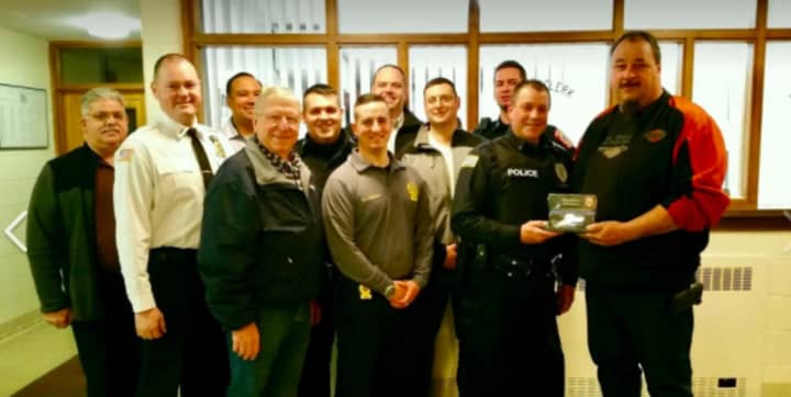 Jeff Ledoux of Hyde Park, owner of Just In Time Towing, was honored by the Hyde Park Police Department this week for rescuing one of its police officers.