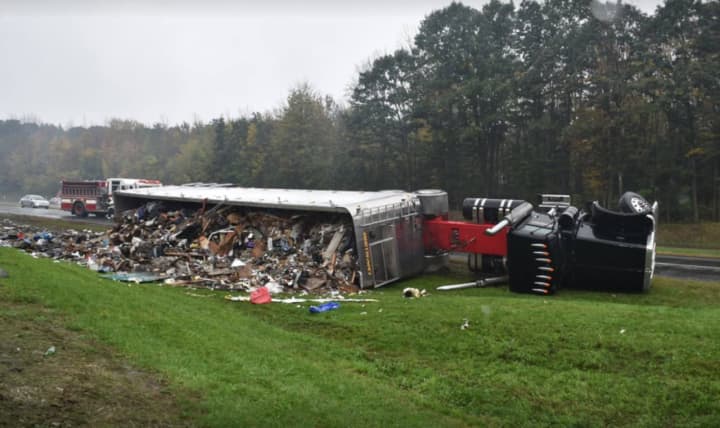 A tractor-trailer flipped on its side after clipping another vehicle.