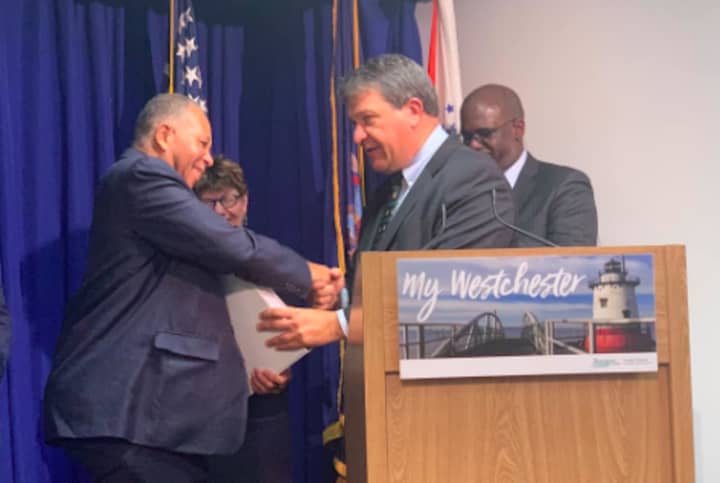County Executive George Latimer passing off his proposed 2019 budget to Board of Legislators Chairman Ben Boykin.