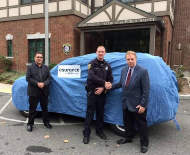 Esurance Senior SIU Major Case Investigator Michael Sepanara (left) Esurance SIU Investigator
John Ferris (right.) Accepting the vehicle donation for the Scarsdale Police Department is Officer Michael Coyne (center).