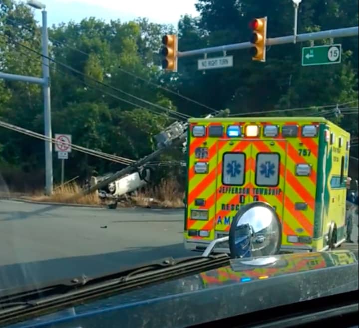 An overturned car knocked down a utility pole, closing Route 15 in Jefferson Thursday.
