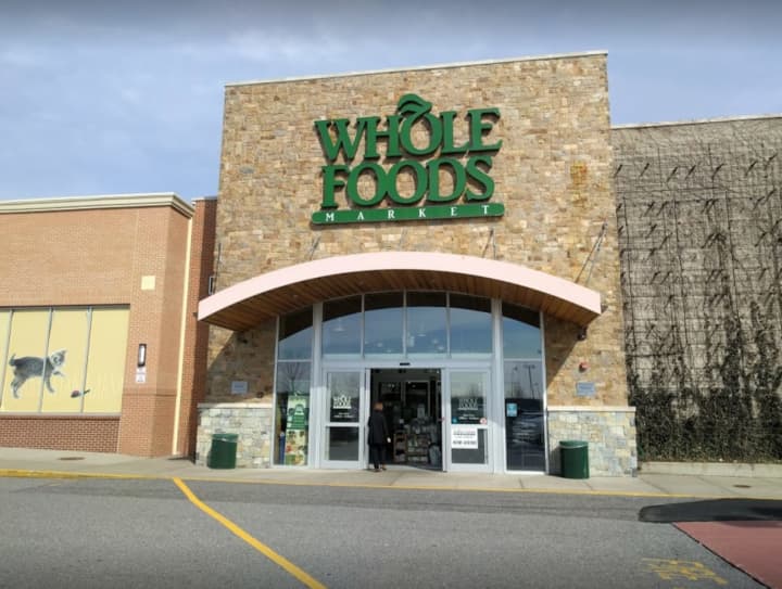 A 23-year-old woman had her car stolen at gunpoint at Whole Foods in Lake Grove.