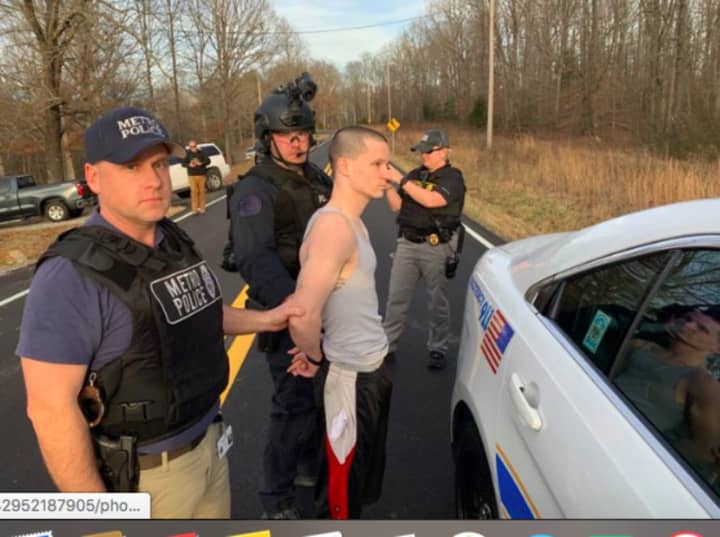 Michael D. Mosley being apprehended by police.