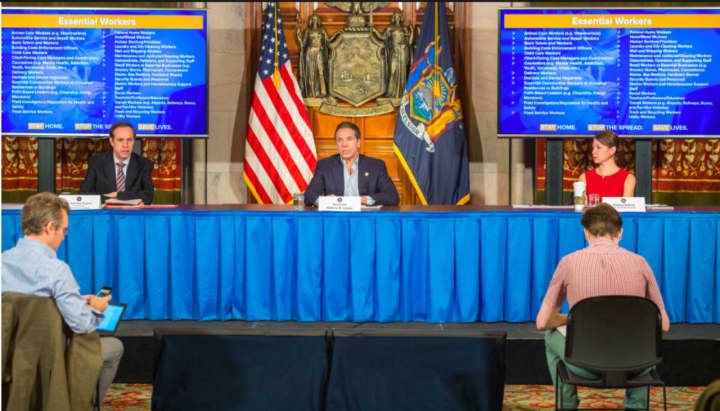 Gov. Andrew Cuomo flanked by state health director Howard Zucker and Cuomo&#x27;s top aide Melissa DeRosa.
