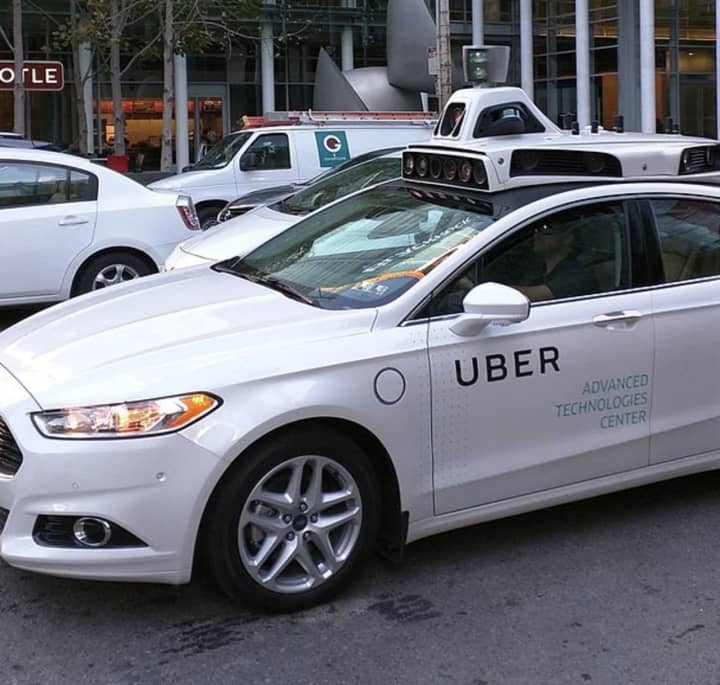 An Uber driver was robbed and attacked by two men posing as police.