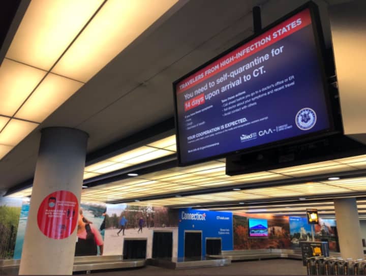 A sign at Bradley Airport in Windsor Locks, Connecticut with information on the COVID-19 tristate travel advisory.
