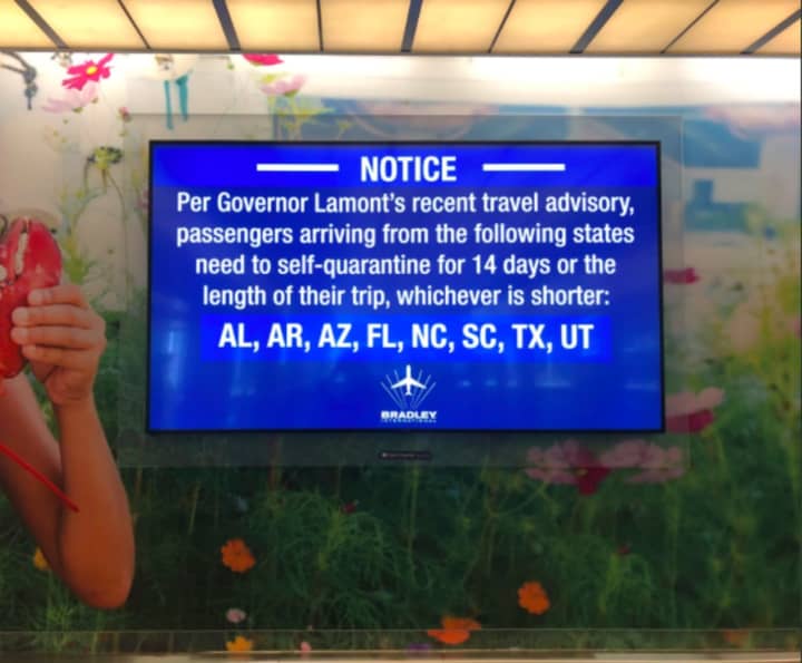 A sign at Bradley Airport in Windsor Locks, Connecticut announcing the first quarantine order on June 25, which included the eight states shown.