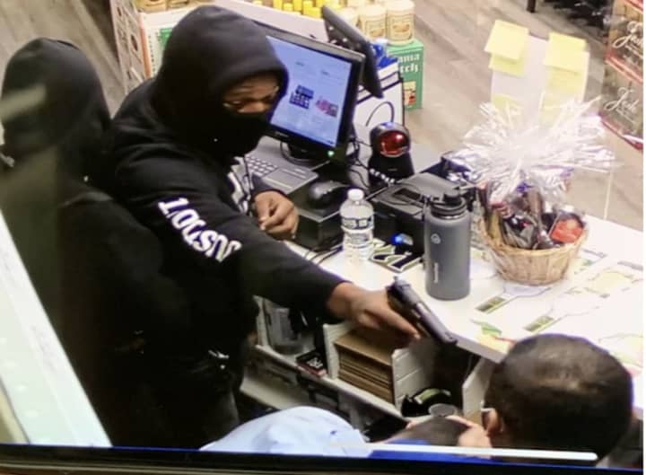 Police are asking the public for help locating two men who robbed a liquor store while holding a gun to the clerk&#x27;s head.