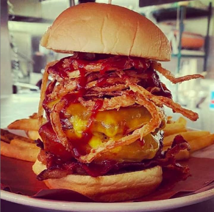 A double &quot;Better with Cheddar&quot; burger, topped with sharp cheddar cheese, crispy bacon, smoky BBQ sauce
and frizzled onions.
